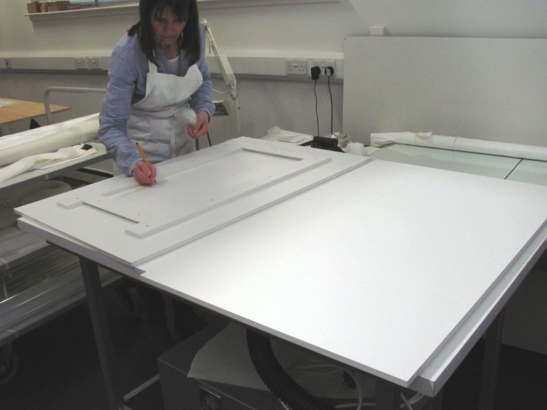 Fig.5. Lisa Cumming with the reverse of the Foamex board showing its support frame and split battens