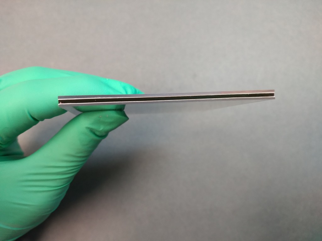 Fig. 12 – The repaired broken glass lantern slide with additional support added. 