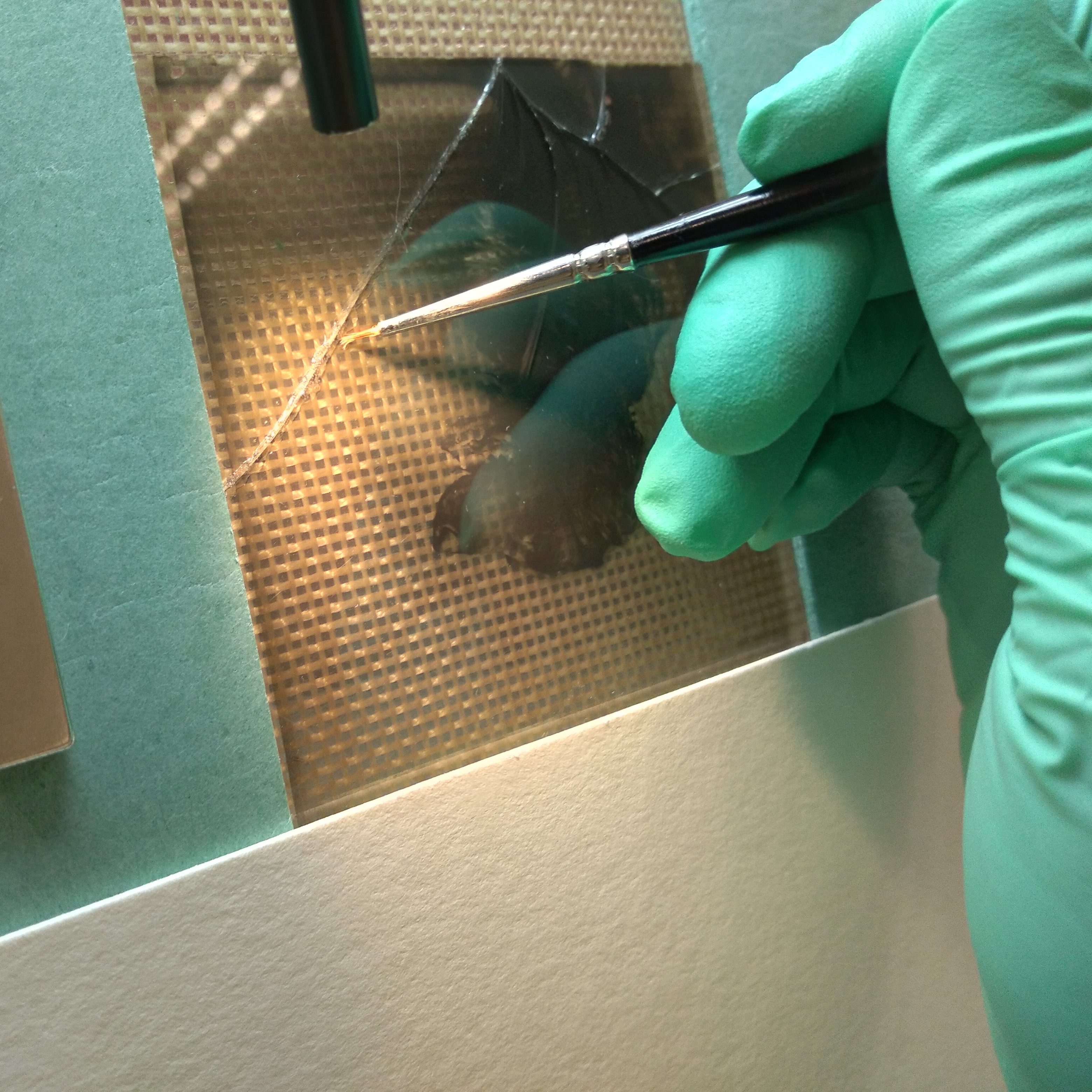 Fig. 9 – Applying the adhesive to a broken glass plate negative from my study collection