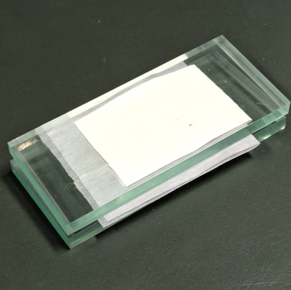 Drying and flattening the endband using Bondina, blotting paper and glass weights.