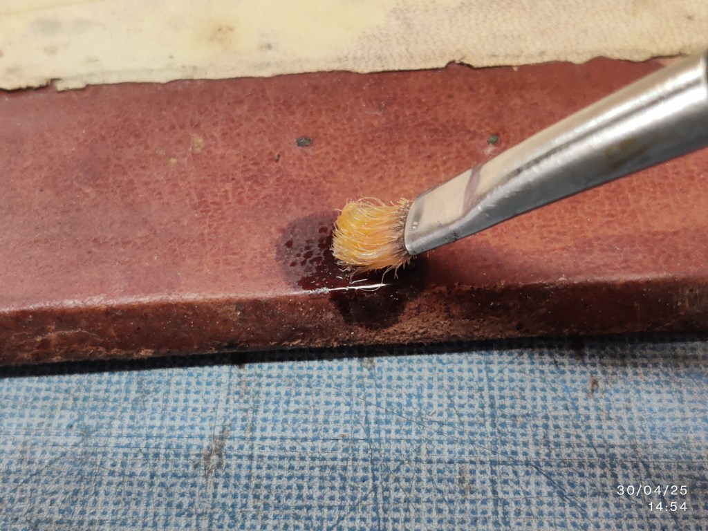 Testing cyclomethicone on the leather before treatment. Photography by Viviana Molinari; courtesy of the Biblioteca San Francesco della Vigna di Venezia.