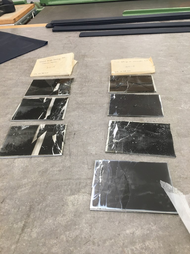Rows of cracked quarter-plate glass negs resting on their stiff paper supports, awaiting stabilisation. Bedfordshire Archives BTNeg collection. Photo by Alison Faden.